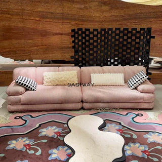 RINGCHEN luxury sculptural cluster jacquard sofa featuring a curved cloud-like silhouette, upholstered in premium textured designer fabric with a sophisticated pink and white micro-pattern, showcasing a low-profile modular frame, deep-seated comfort, and distinctive leather strap detailing on the rounded armrests for high-end living room interiors.-Front view