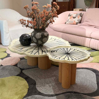RINGCHEN sculptural lily pad coffee table set featuring irregular lotus leaf-shaped natural stone tops with intricate radial veining, supported by a cluster of solid wood pedestal bases. This luxury nesting coffee table set showcases a unique organic design with carved scalloped edges, blending artisanal craftsmanship with mid-century modern organic aesthetics for high-end designer living rooms.-Diagonal view