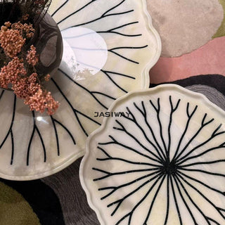 RINGCHEN sculptural lily pad coffee table set featuring irregular lotus leaf-shaped natural stone tops with intricate radial veining, supported by a cluster of solid wood pedestal bases. This luxury nesting coffee table set showcases a unique organic design with carved scalloped edges, blending artisanal craftsmanship with mid-century modern organic aesthetics for high-end designer living rooms.-Top down view