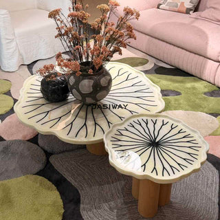 RINGCHEN sculptural lily pad coffee table set featuring irregular lotus leaf-shaped natural stone tops with intricate radial veining, supported by a cluster of solid wood pedestal bases. This luxury nesting coffee table set showcases a unique organic design with carved scalloped edges, blending artisanal craftsmanship with mid-century modern organic aesthetics for high-end designer living rooms.-High-angle view