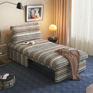 A brown and white striped sherpa convertible sleeper sofa is fully extended in a cozy living room, styled with a brown throw blanket, open book, and warm ambient lighting.