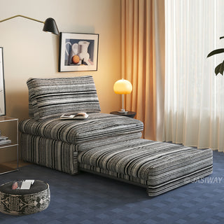 A black and white striped sherpa convertible sleeper sofa is shown in a partially extended pull-out configuration within a modern, warmly lit living room.