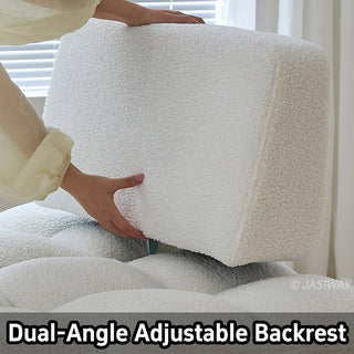 A close-up shot shows a person's hands adjusting the backrest of a white sherpa modular armchair. The soft, textured upholstery and blocky tufted design highlight the piece's versatile functionality. A text label at the bottom reads "Dual-Angle Adjustable Backrest."