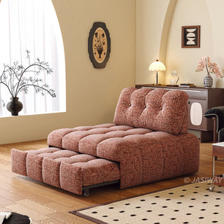 A rust red tufted chenille convertible sleeper sofa is shown in a partially pulled-out bed configuration within a warmly styled modern living room.