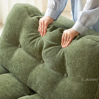 A close-up shot highlights the plush, supportive cushioning and tufted button details of the olive green chenille fabric on a convertible sleeper sofa.