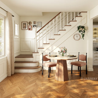 Wide-angle lifestyle shot of a bright residential dining room featuring a modern round sintered stone dining table with a creamy onyx patterned top and a faceted wooden pedestal base, paired with textured upholstered chairs and herringbone flooring near a staircase.